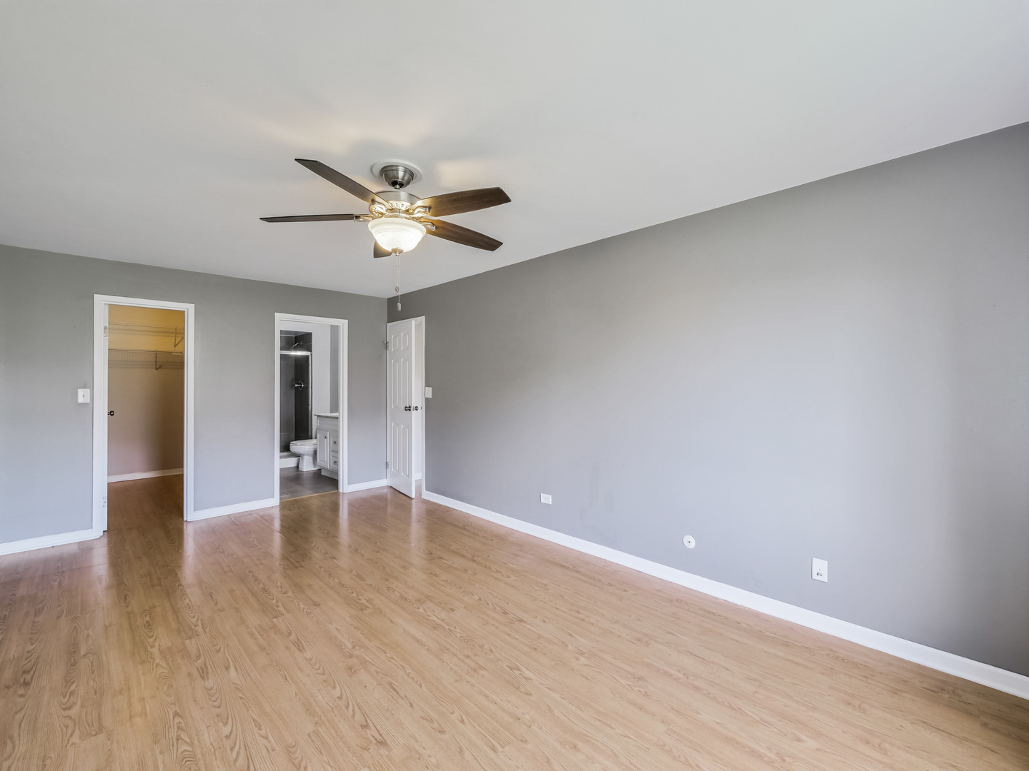 1747 West Crystal Lane, Unit 210 Mount Prospect, IL 60056 - Photo 10 of 33 wooden floor in an empty room with a window