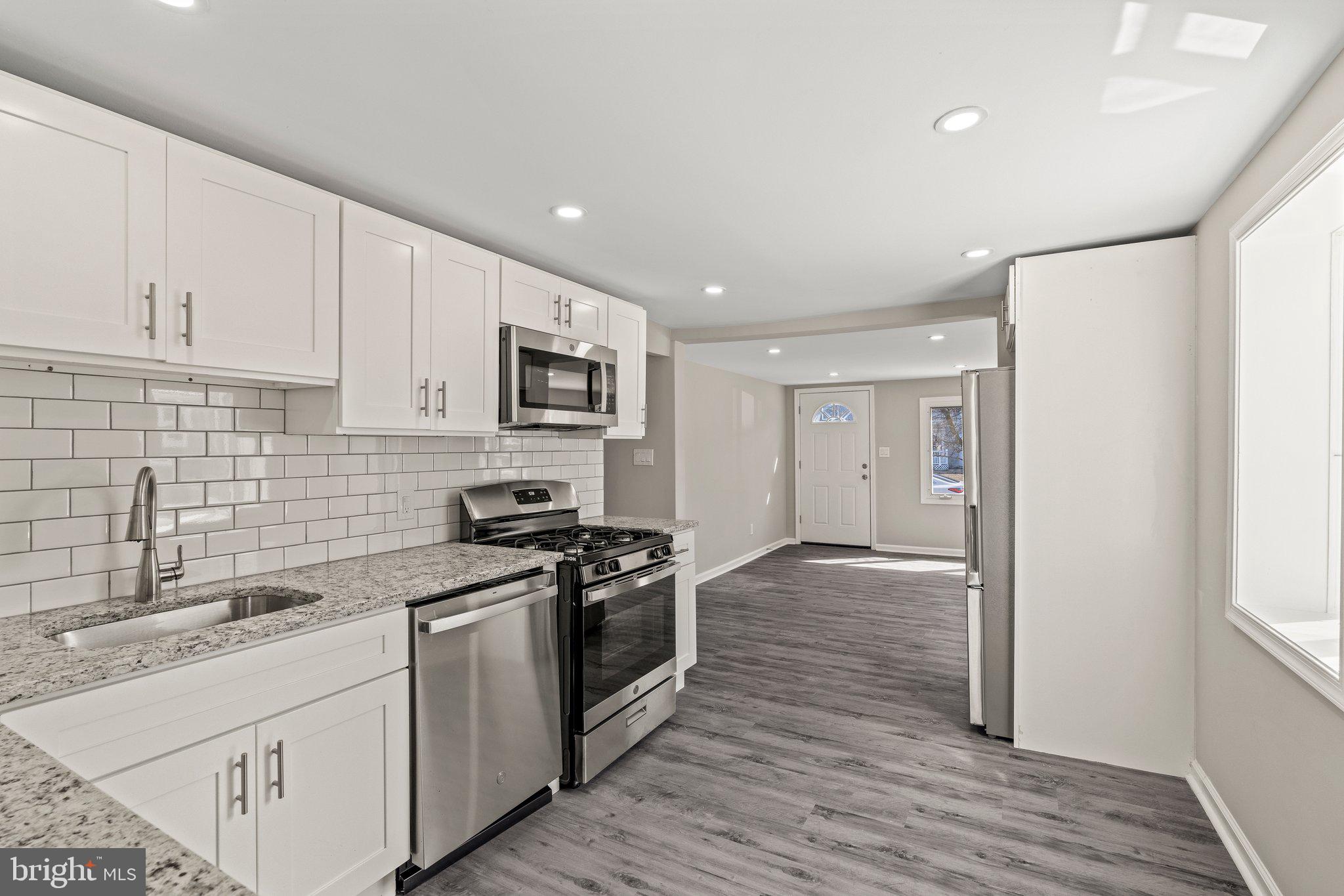 29 East 4th Street Burlington, NJ 08016 - Photo 12 of 27 a kitchen with stainless steel appliances granite countertop a stove and a sink