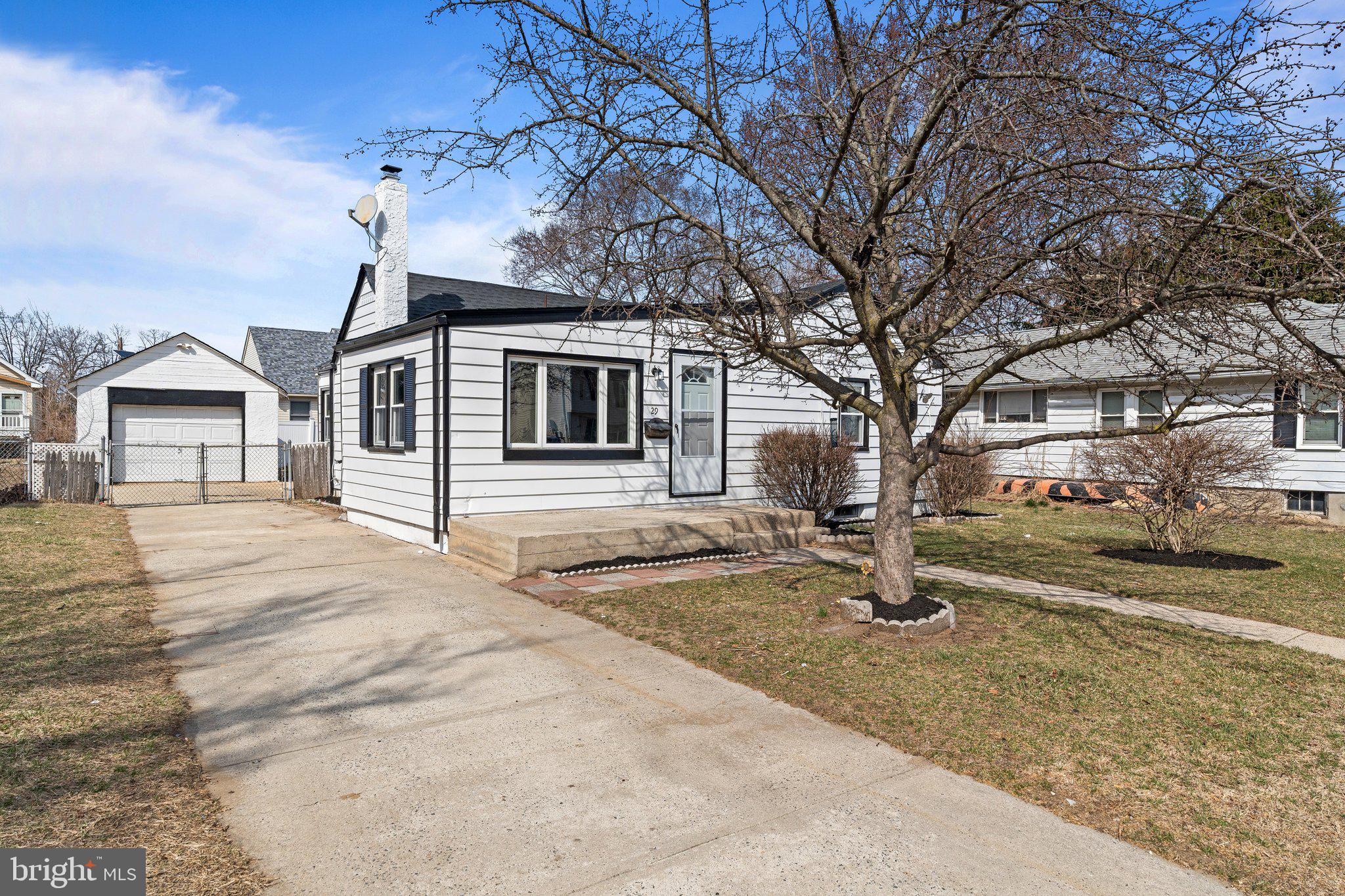 29 East 4th Street Burlington, NJ 08016 - Photo 2 of 27 a front view of a house with a yard and garage