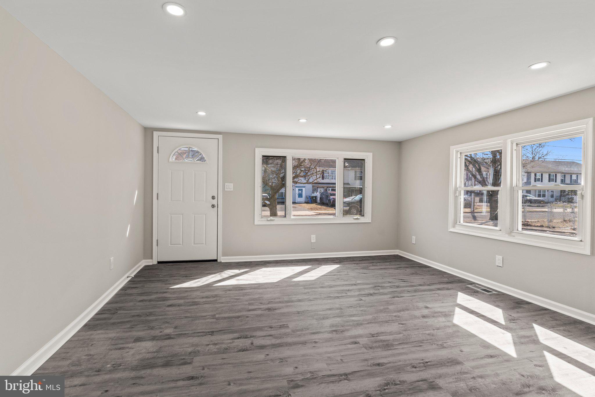 29 East 4th Street Burlington, NJ 08016 - Photo 7 of 27 a view of an empty room with a window and wooden floor