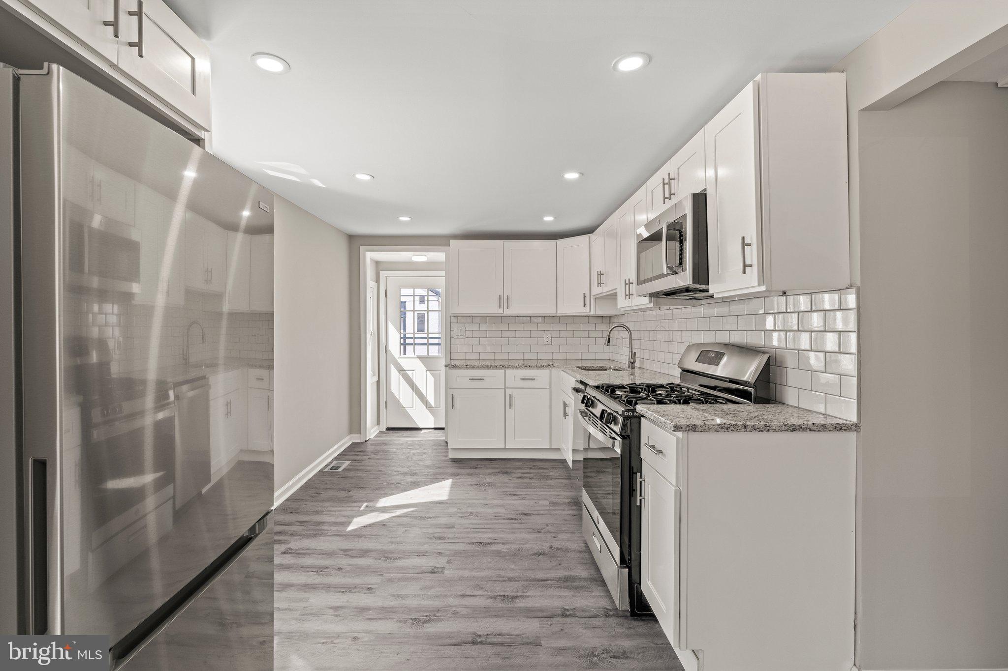 29 East 4th Street Burlington, NJ 08016 - Photo 8 of 27 a kitchen with stainless steel appliances granite countertop a stove a refrigerator and a refrigerator