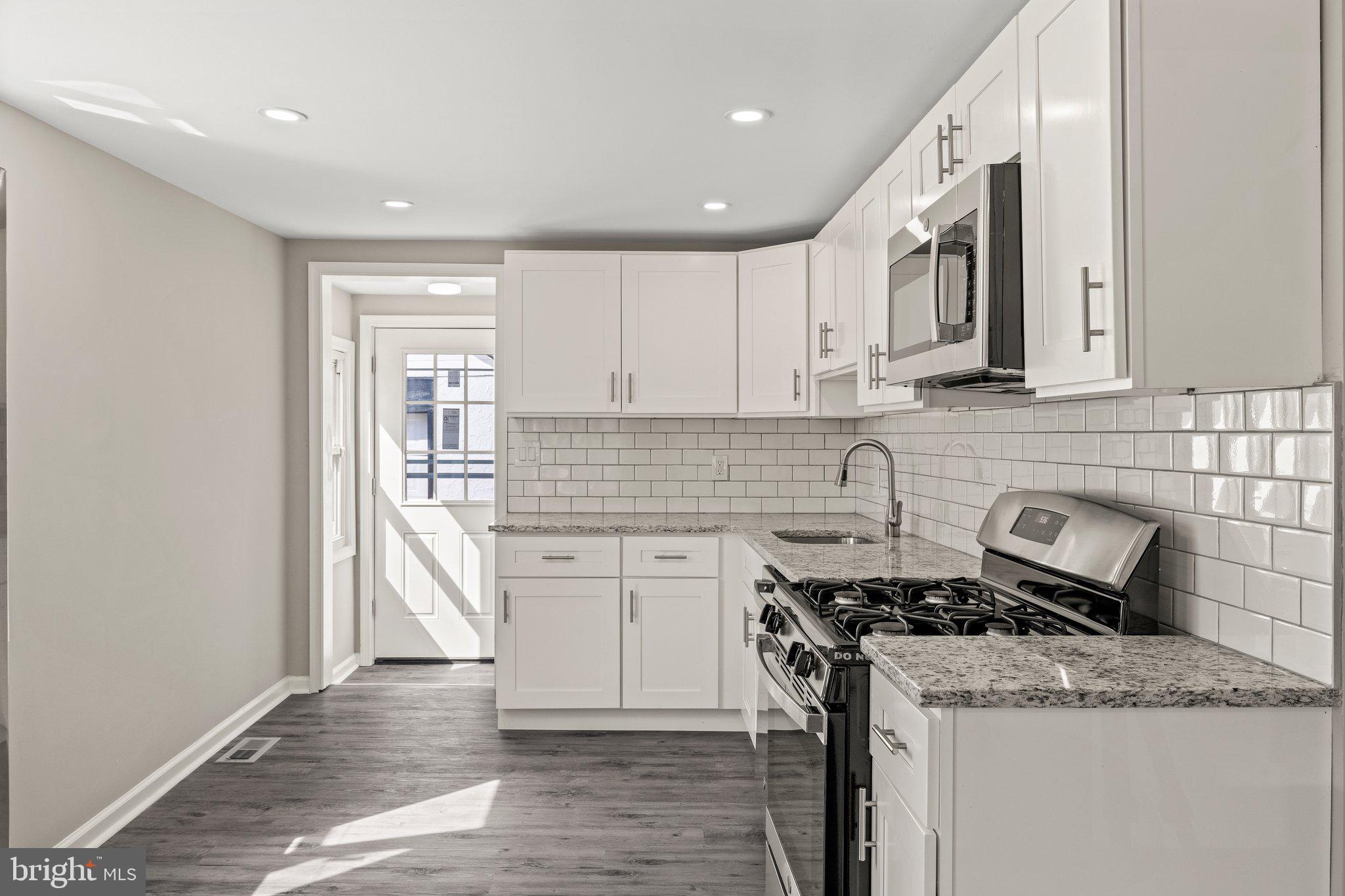 29 East 4th Street Burlington, NJ 08016 - Photo 9 of 27 a kitchen with stainless steel appliances granite countertop a sink stove and cabinets