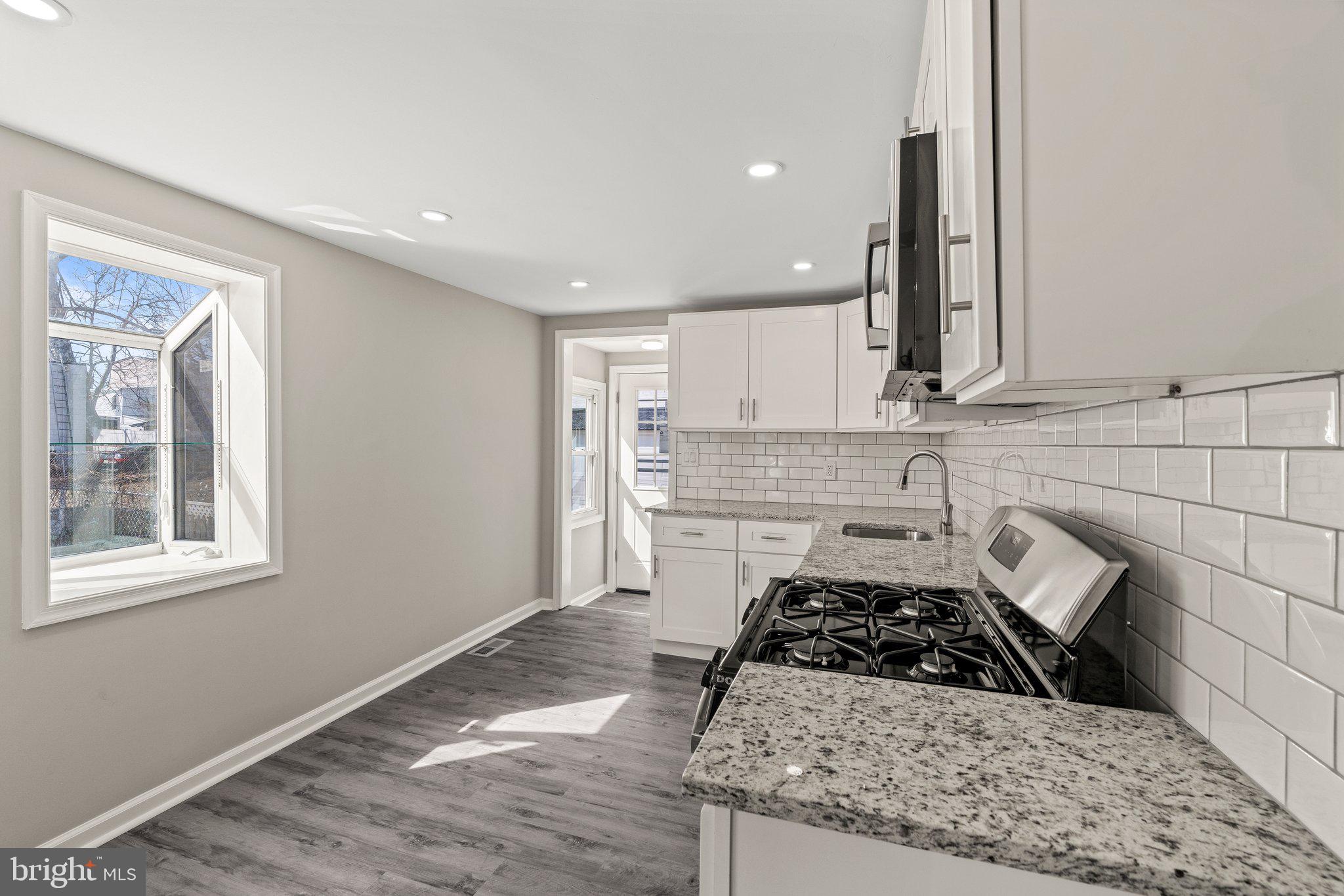 29 East 4th Street Burlington, NJ 08016 - Photo 10 of 27 a kitchen with stainless steel appliances granite countertop a sink stove and cabinets