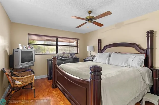 a bedroom with a bed and ceiling fan