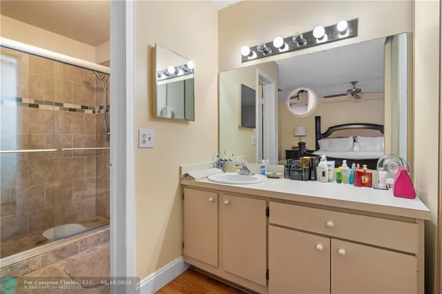 a bathroom with a double vanity sink mirror and shower
