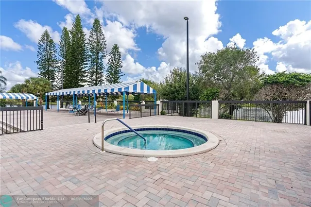 a swimming pool with outdoor seating and yard in back
