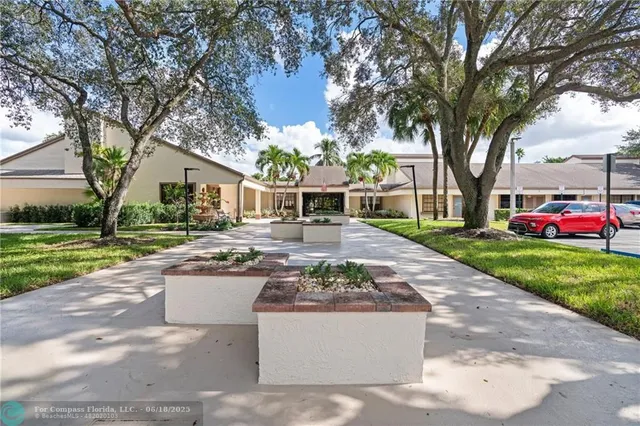 a view of a house with backyard and a tree