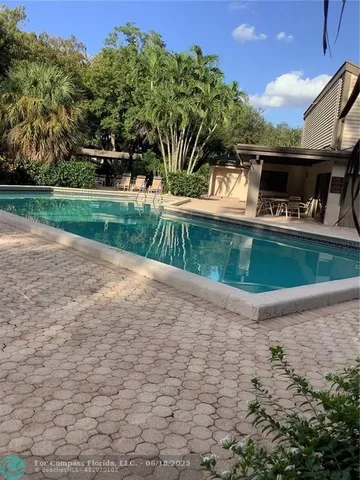 a view of yard with tree in the background