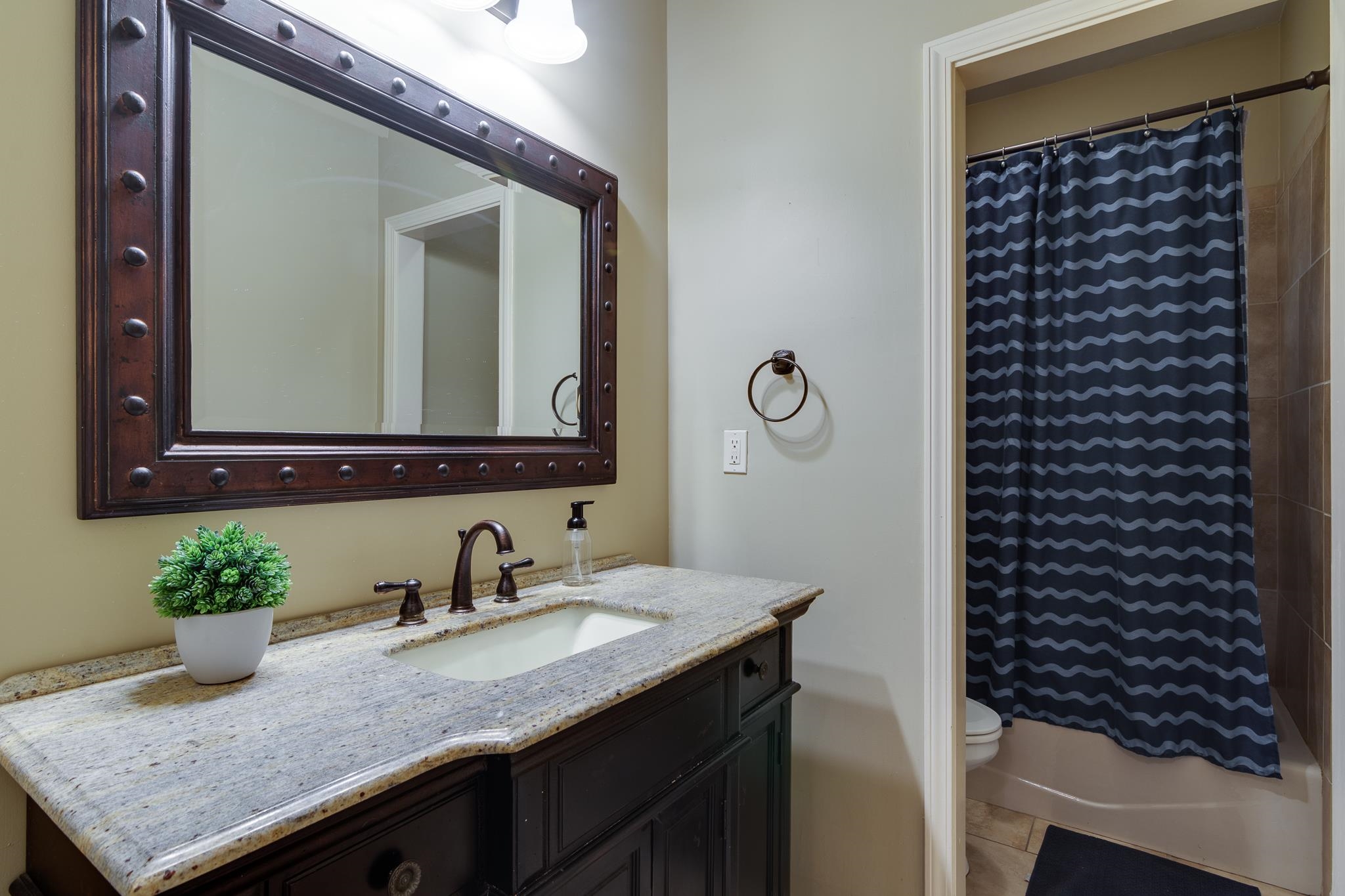 791 North Tree Drive Collierville, TN 38017 - Photo 17 of 27 Bathroom featuring a dark wood vanity with a light speckled countertop and undermount sink