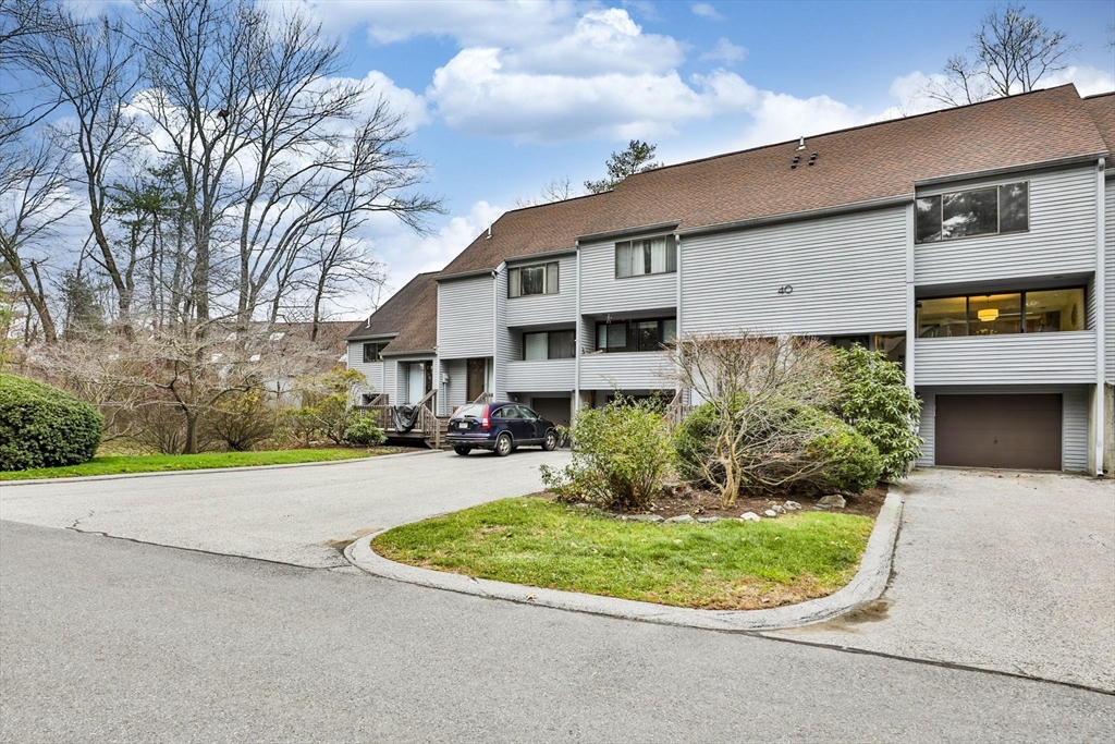 405 Great Elm Way, Unit 405 Acton, MA 01718 - Photo 1 of 19 a front view of a house with a yard and potted plants