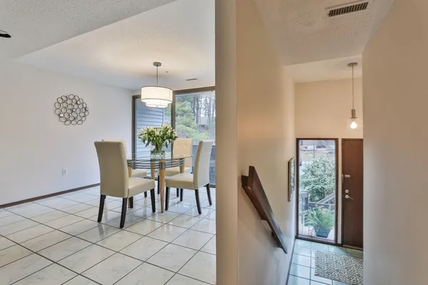 a dining room with furniture and a window