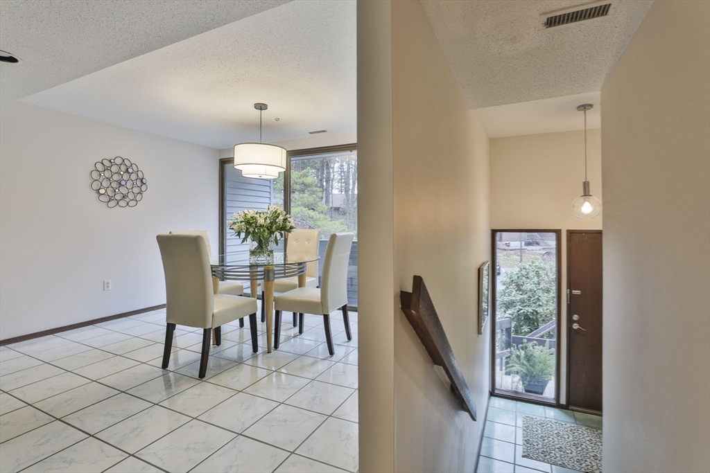 405 Great Elm Way, Unit 405 Acton, MA 01718 - Photo 11 of 19 a dining room with furniture and a window