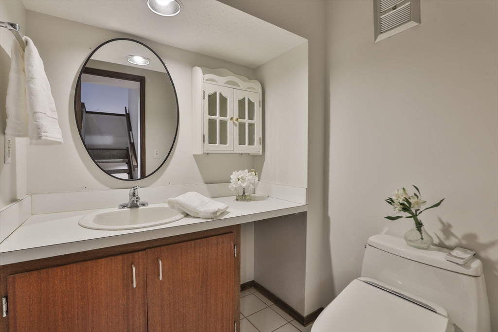 405 Great Elm Way, Unit 405 Acton, MA 01718 - Photo 12 of 19 a bathroom with a sink and a mirror
