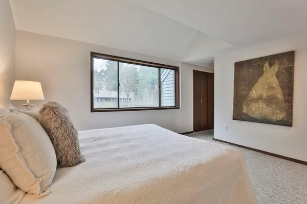 a view of a bedroom with a large bed and a large window