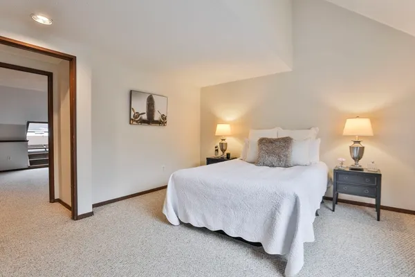 a bedroom with a bed and a lamp