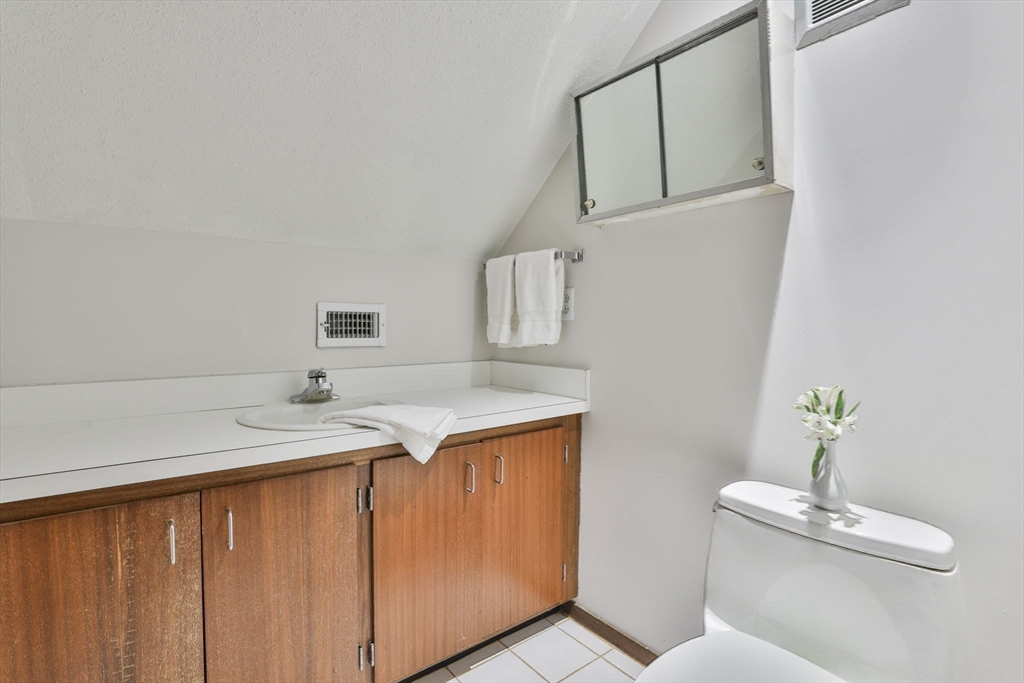 405 Great Elm Way, Unit 405 Acton, MA 01718 - Photo 18 of 19 a bathroom with a granite countertop sink and a toilet