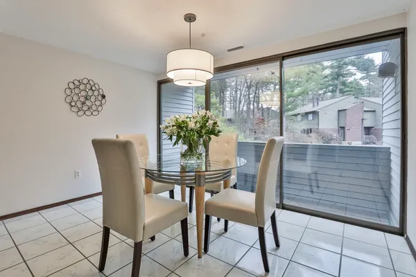 a dining room view with a table and chairs