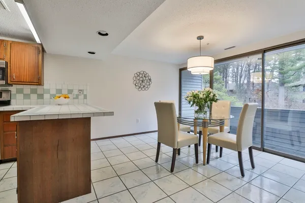 a dining room with furniture and window