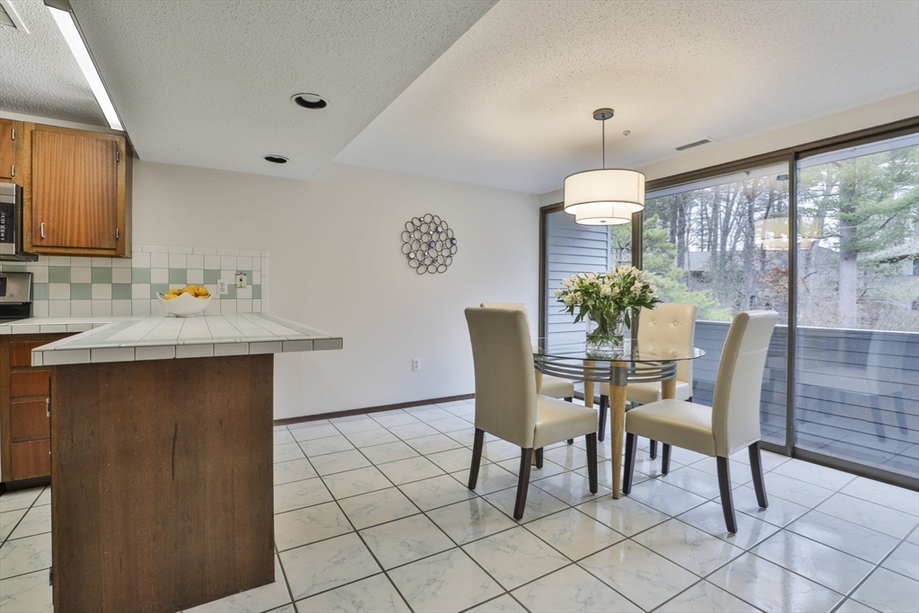 405 Great Elm Way, Unit 405 Acton, MA 01718 - Photo 5 of 19 a dining room with furniture and window