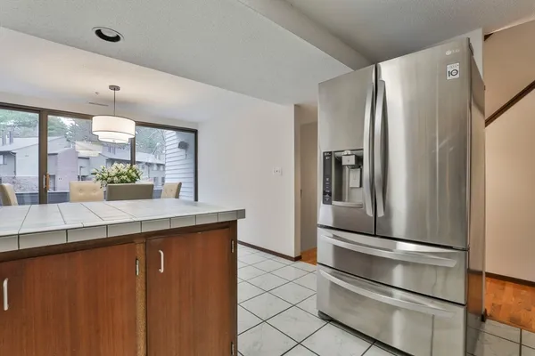 a kitchen with stainless steel appliances a refrigerator and cabinets
