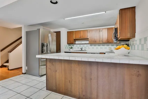 a kitchen with stainless steel appliances a sink stove and cabinets
