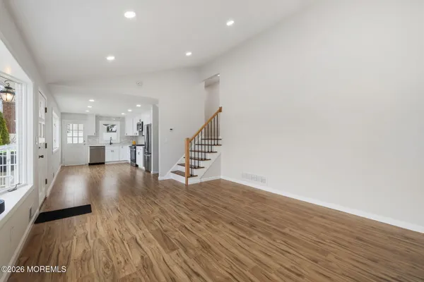 a kitchen with a white cabinets a sink a window a stainless steel appliances and a window