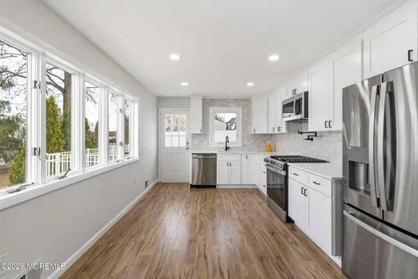 a kitchen with a refrigerator a sink and cabinets