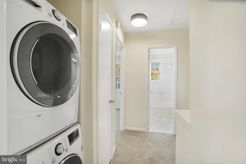 a view of a hallway with washer and dryer