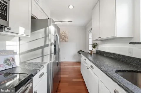 a kitchen with a sink and a stove top oven
