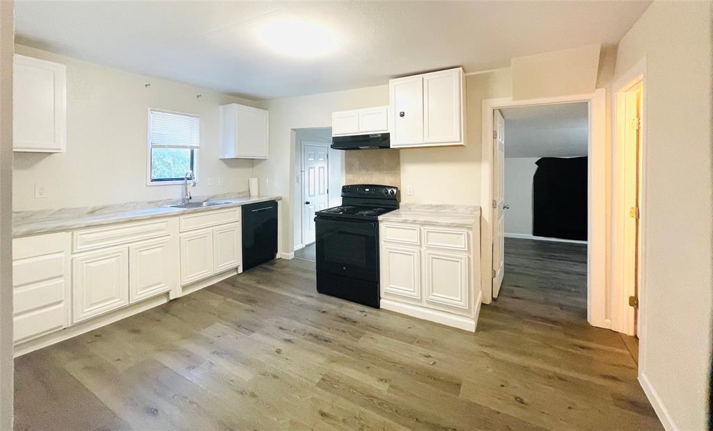 111 Rousseau Street Waxahachie, TX 75165 - Photo 11 of 22 a kitchen with white cabinets and appliances