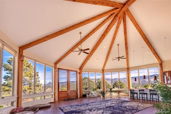 a bed room with a bed and large windows