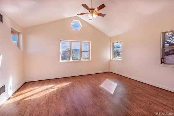 a view of an empty room window and wooden floor