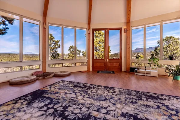a living room with furniture and a floor to ceiling window