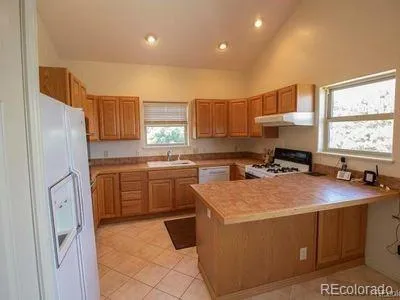 a kitchen with a sink appliances and cabinets