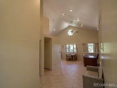 a view of a livingroom and a kitchen with furniture