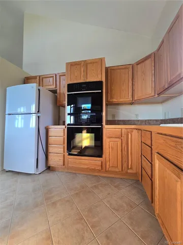 a kitchen with granite countertop a stove and a cabinets