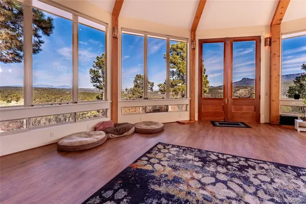 a living room with furniture and a floor to ceiling window