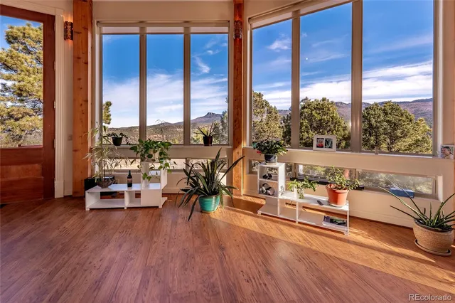 a view of a living room with furniture and floor to ceiling windows