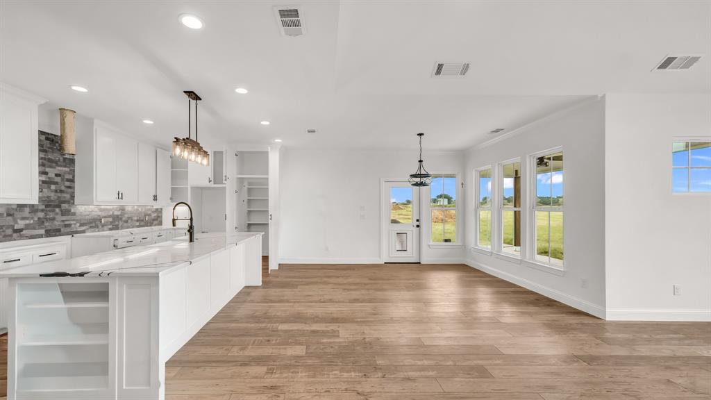 3451 Carraway Tbd County Road Paradise, TX 76073 - Photo 24 of 24 a large white kitchen with a lot of counter space and wooden floor