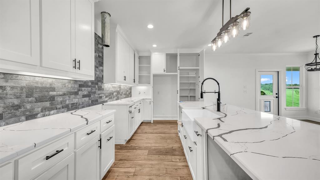 3451 Carraway Tbd County Road Paradise, TX 76073 - Photo 9 of 24 a large white kitchen with lots of counter space and chandelier
