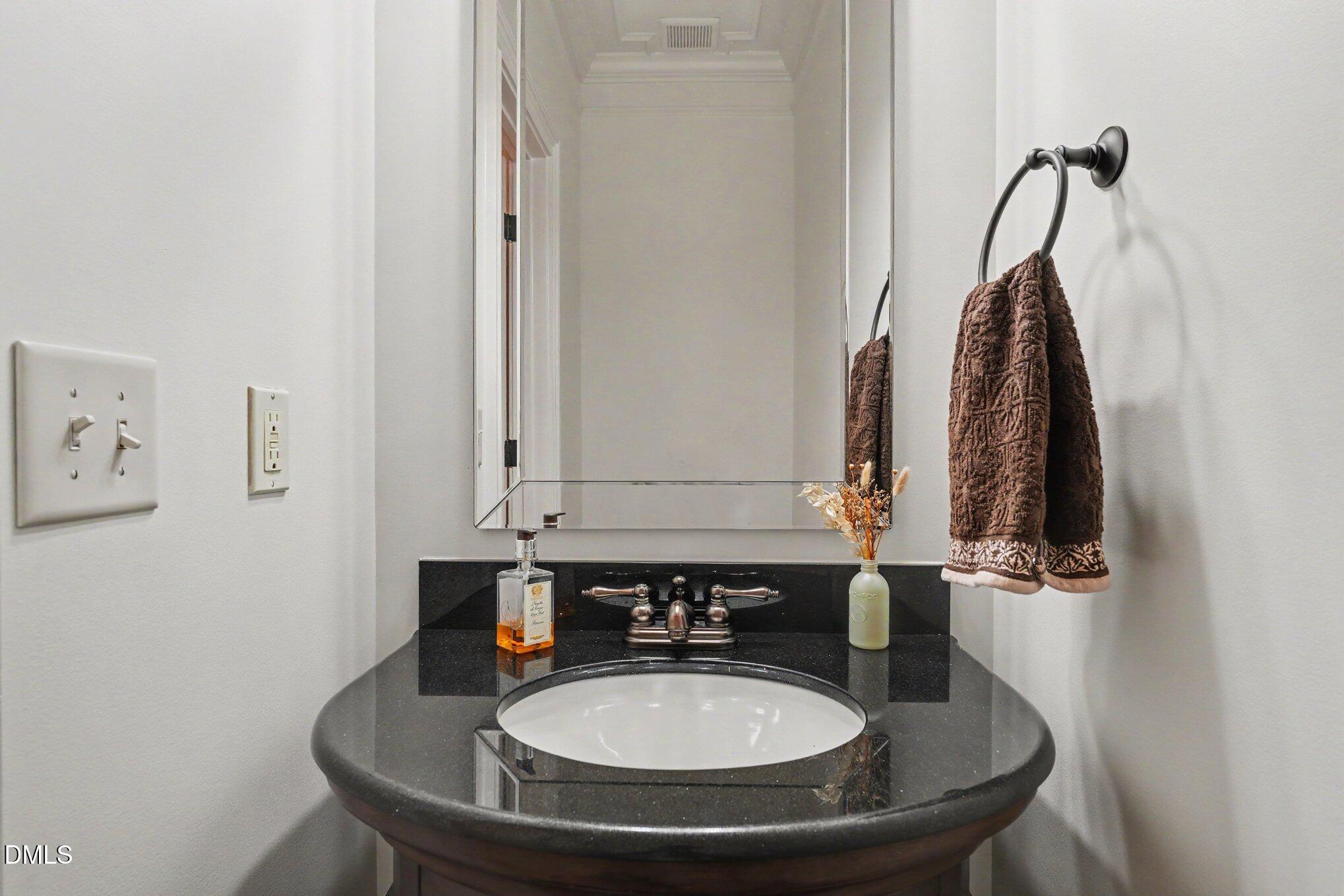 1729 Frenchwood Drive Raleigh, NC 27612 - Photo 29 of 46 a bathroom with a sink and a mirror
