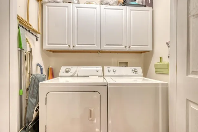 a living room with furniture a flat screen tv and a table