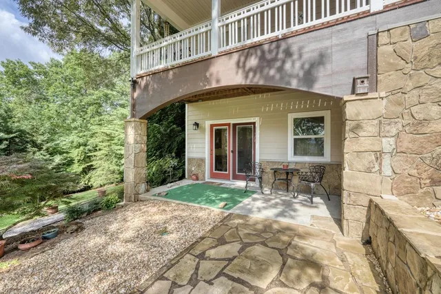 a view of a backyard house with large trees