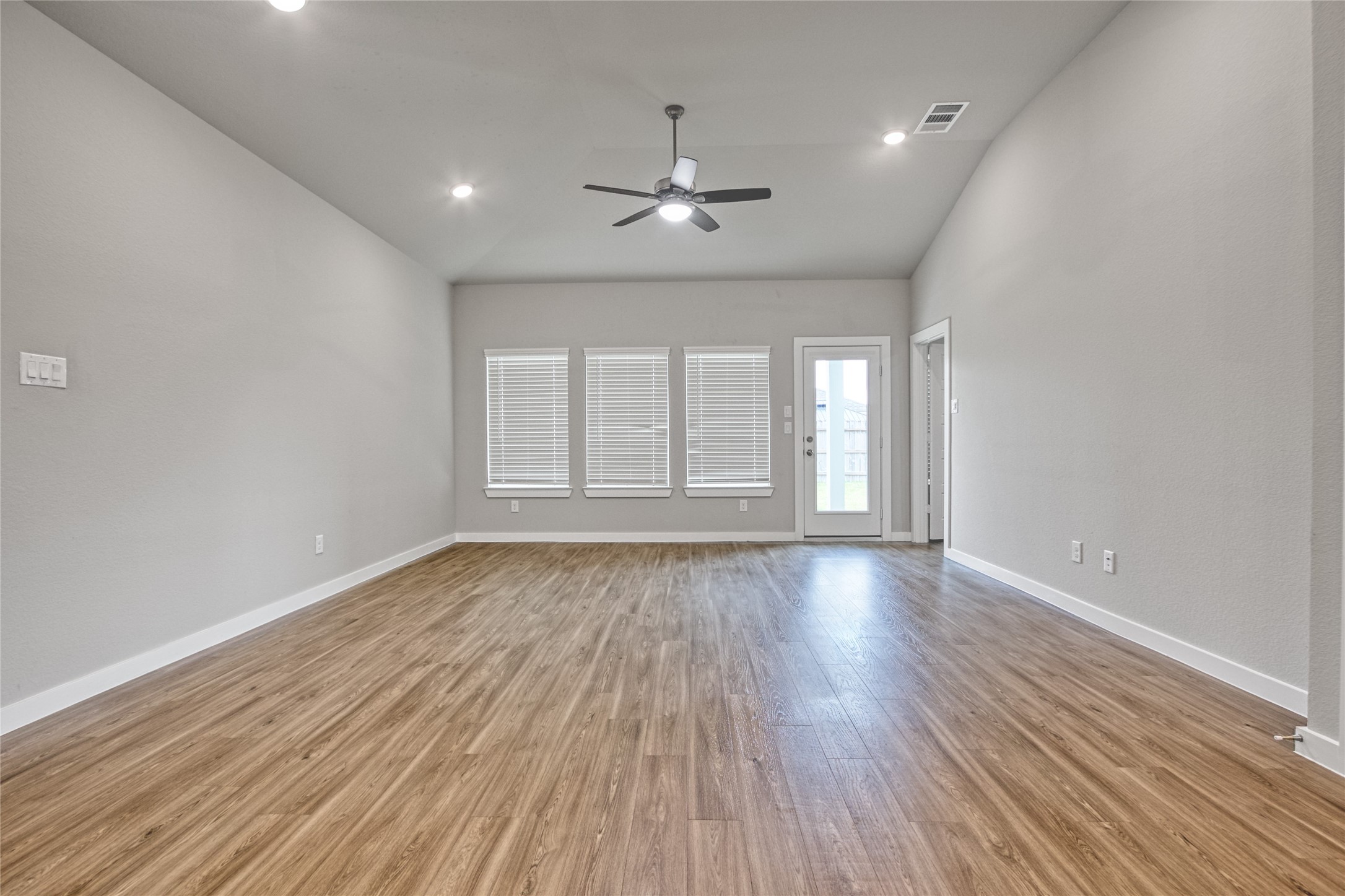 3327 Trl Vw Drive Rosenberg, TX 77471 - Photo 11 of 30 wooden floor in an empty room with a window