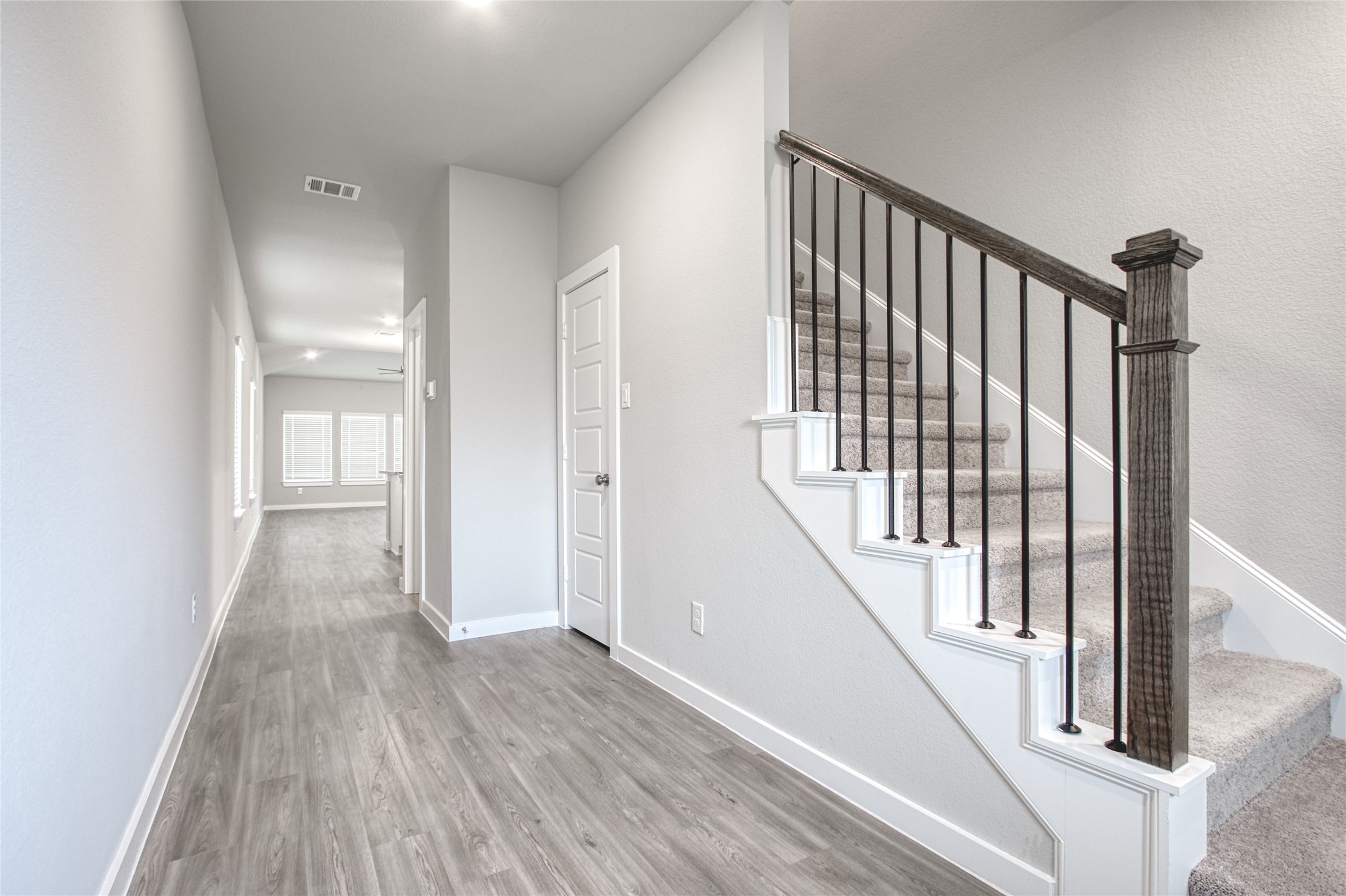 3327 Trl Vw Drive Rosenberg, TX 77471 - Photo 2 of 30 a view of a hallway with wooden floor and staircase