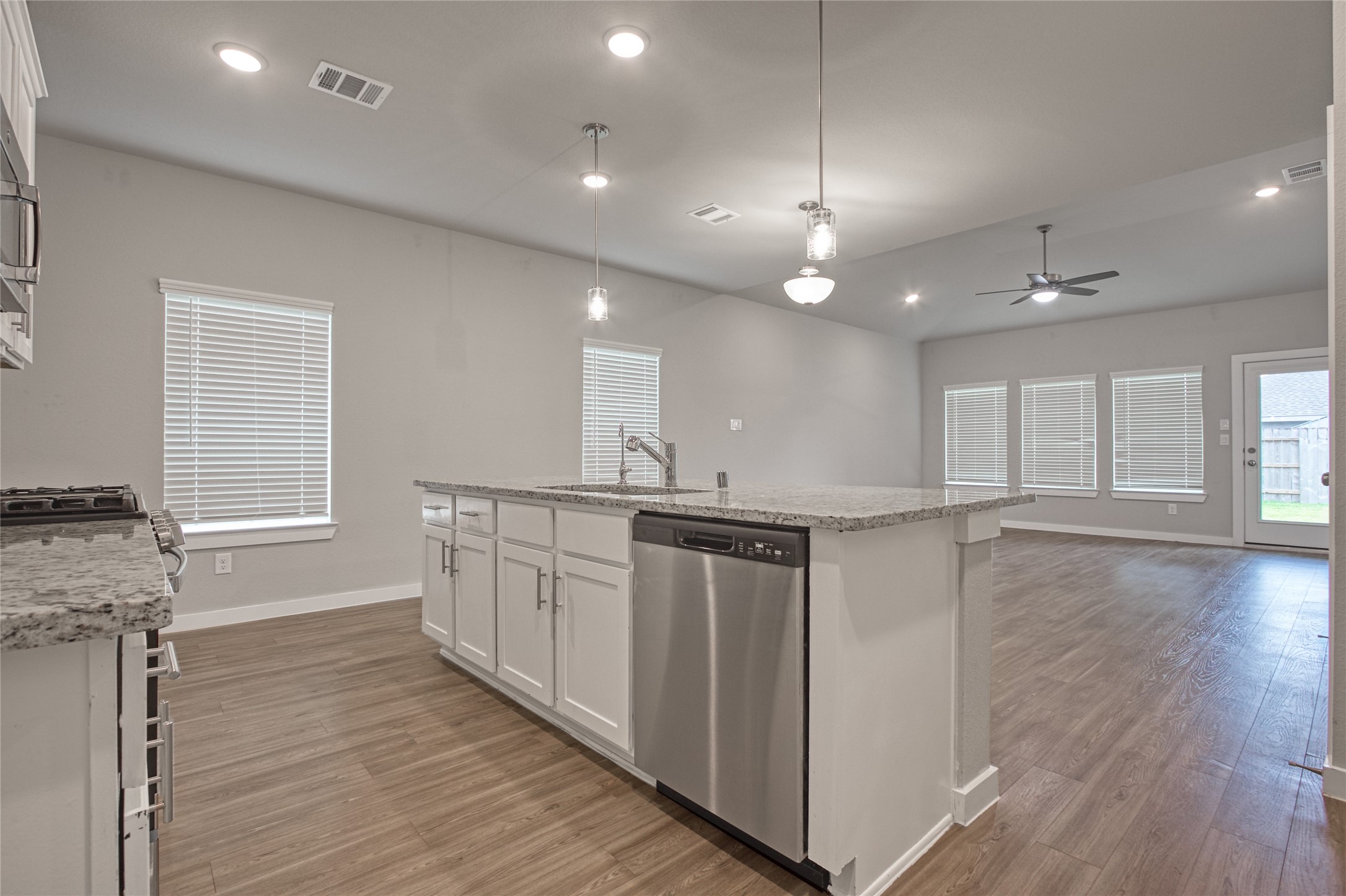 3327 Trl Vw Drive Rosenberg, TX 77471 - Photo 6 of 30 a kitchen with granite countertop a stove top oven a sink a counter space and cabinets