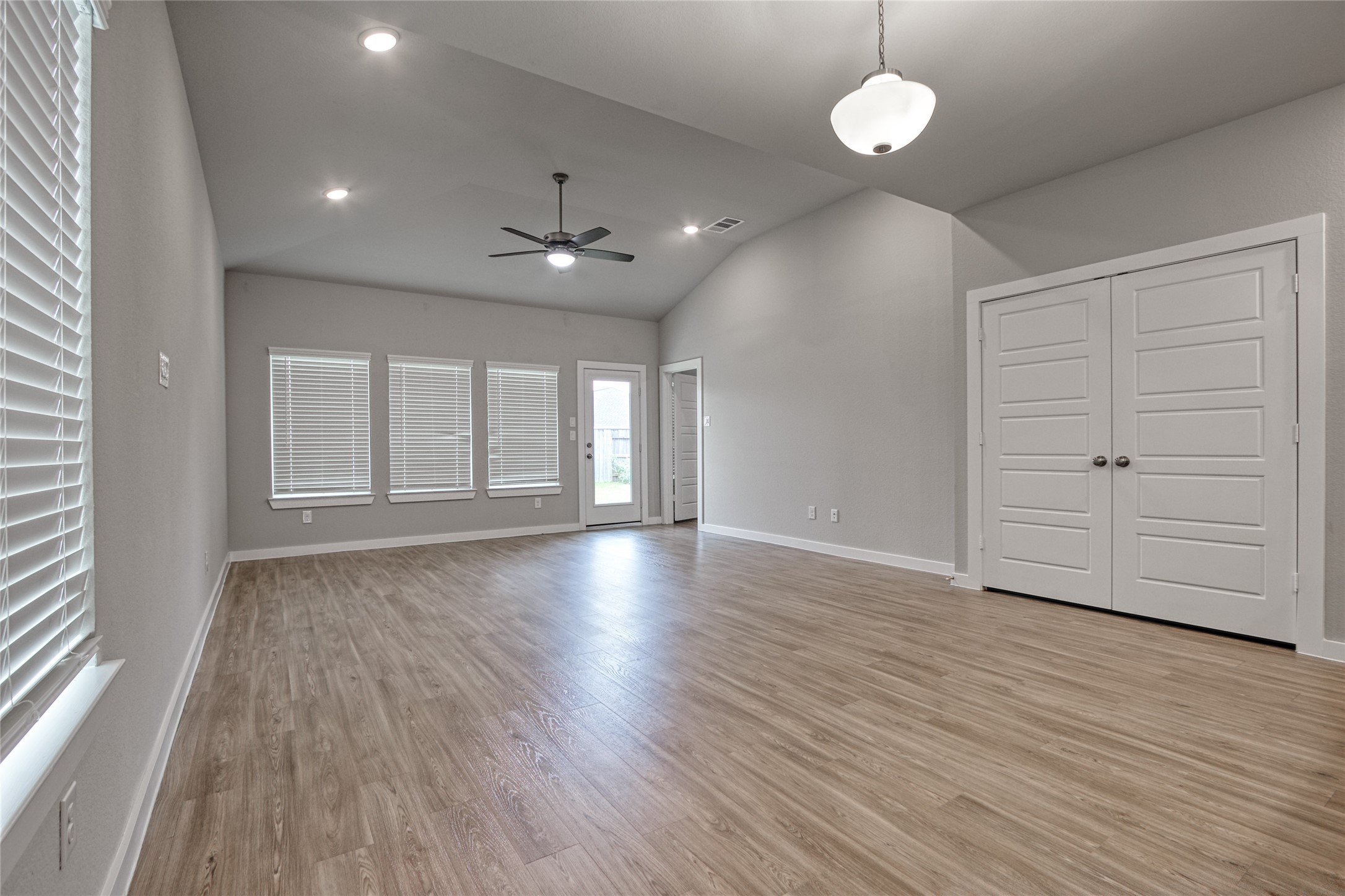3327 Trl Vw Drive Rosenberg, TX 77471 - Photo 10 of 30 an empty room with wooden floor and windows