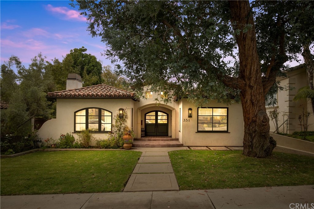 a front view of a house with a garden