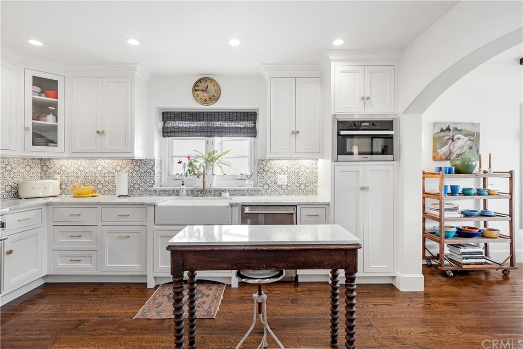 351 Whiting Street El Segundo, CA 90245 - Photo 14 of 60 a kitchen with stainless steel appliances a dining table chairs stove and cabinets