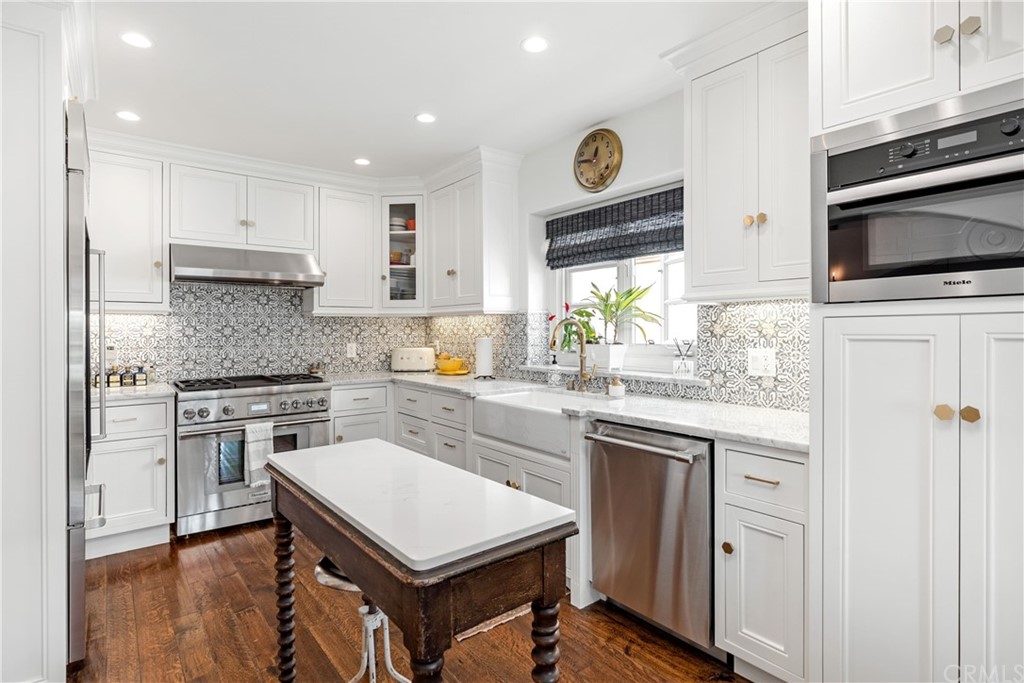 351 Whiting Street El Segundo, CA 90245 - Photo 15 of 60 a kitchen with a stove a sink and a refrigerator